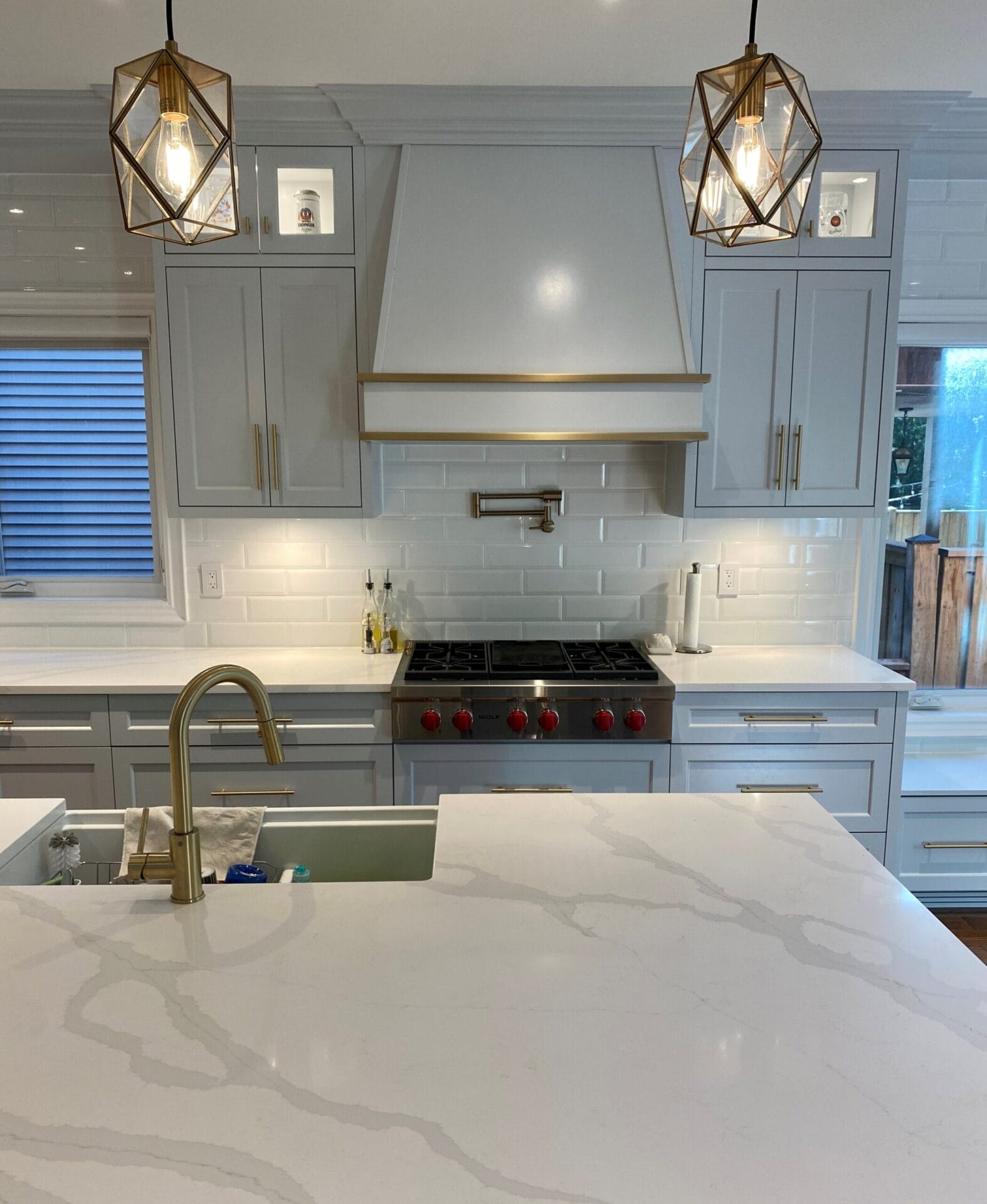 Kitchen renovation in Scarborough featuring new cabinets, marble countertops, custom backsplash, and pot lights.